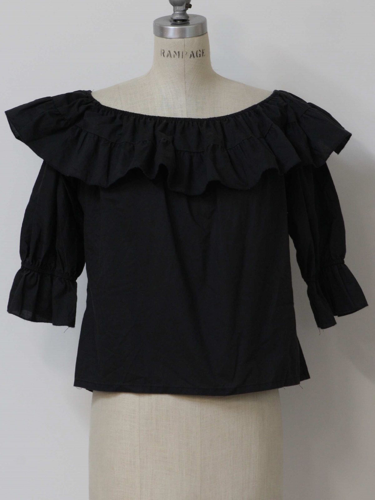 70s -Size Label- Womens faded black pullover cotton blend square dance inspired ruffled hippie shirt with elastic boat neckline, elastic gathered three quarter length sleeves and box cut hem.