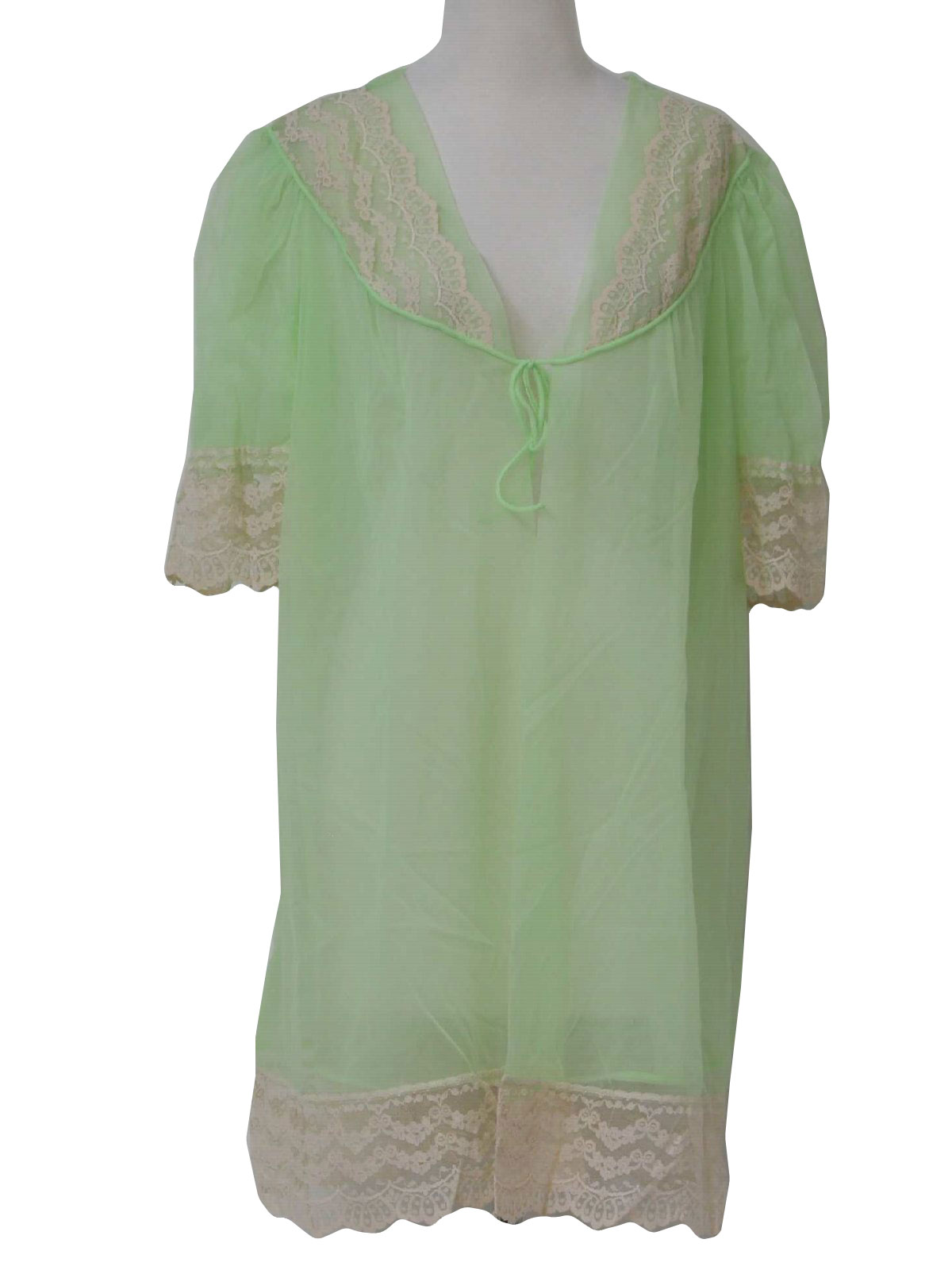 70s -Care Label- Womens light green sheer nylon mid length nightie with single tie off closure at v-neckline, lace trim and half sleeves.