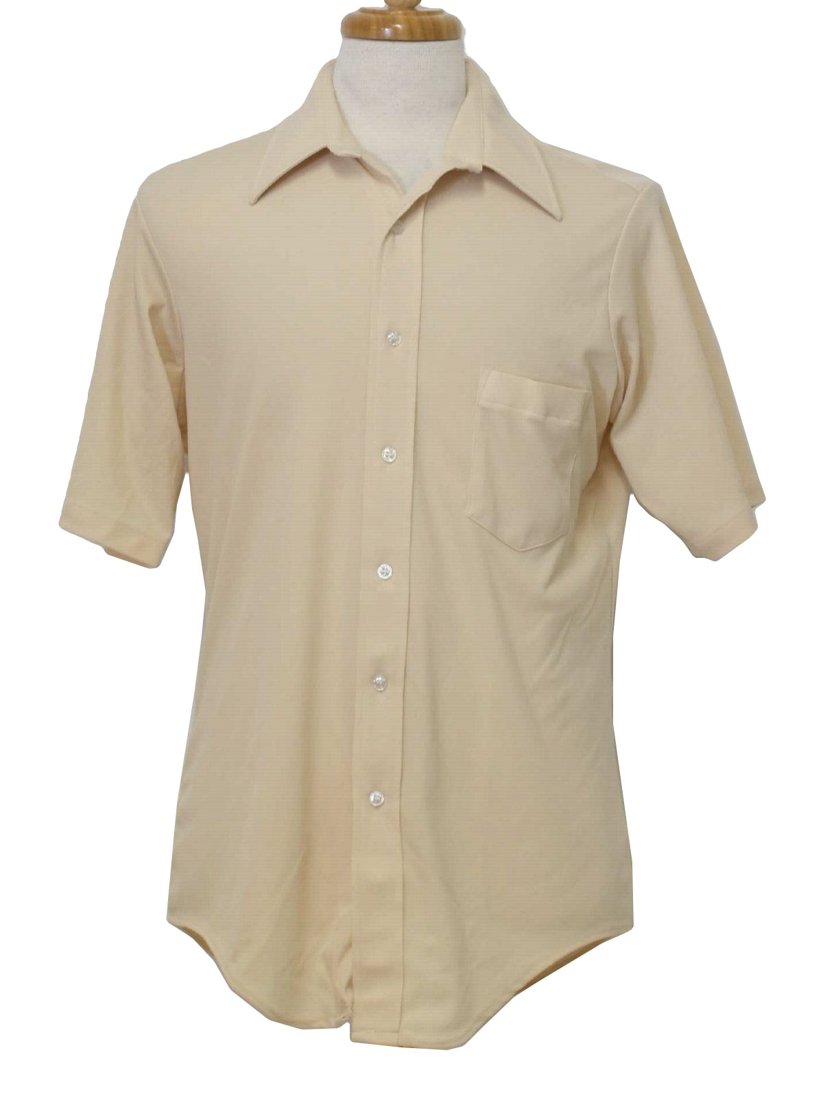 70s -Van Heusen- Mens beige blush polyester short sleeve shirt. A left chest pocket, fold over collar and button front with shirttail hem.