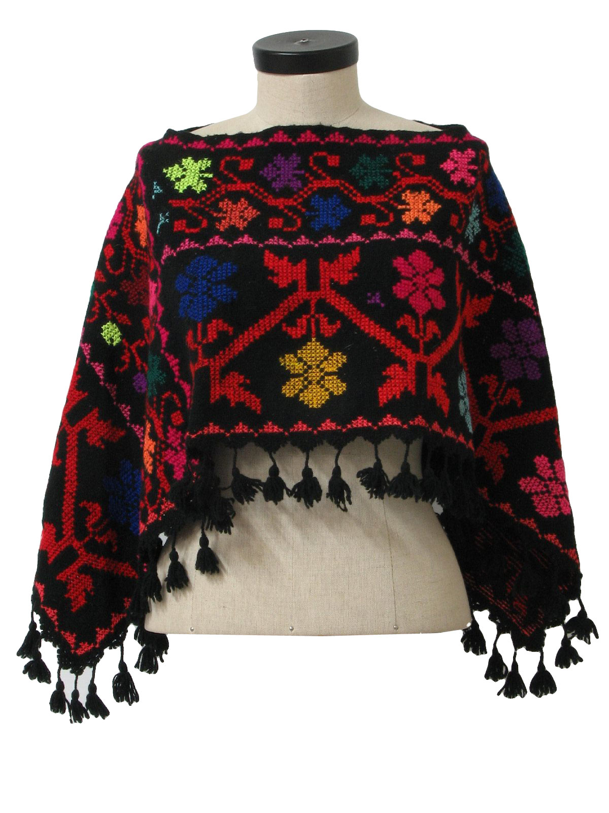 70s style (made more recently) -Missing Label- Womens black, red, pink, purple, orange, yellow, green and blue floral print acrylic hippie style poncho with fringed bottom hem.