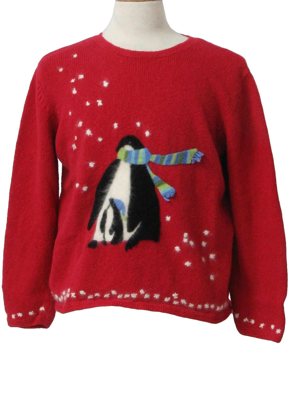 80s style -Northern Isles- Womens red background cotton ramie blend longsleeve pullover Ugly Christmas sweater with fuzzy angora snowflakes falling on holiday penguins at center chest.