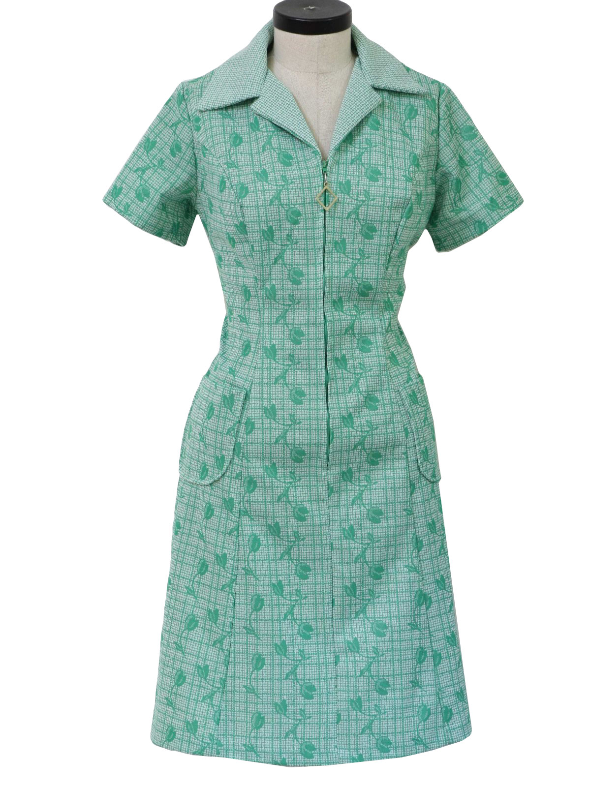 Vintage Seventies Dress 70s no label Womens white base with bright green plaid and floral patterns short sleeve mid length polyester double knit dress. Fold over collar in coordinating patterns fron...