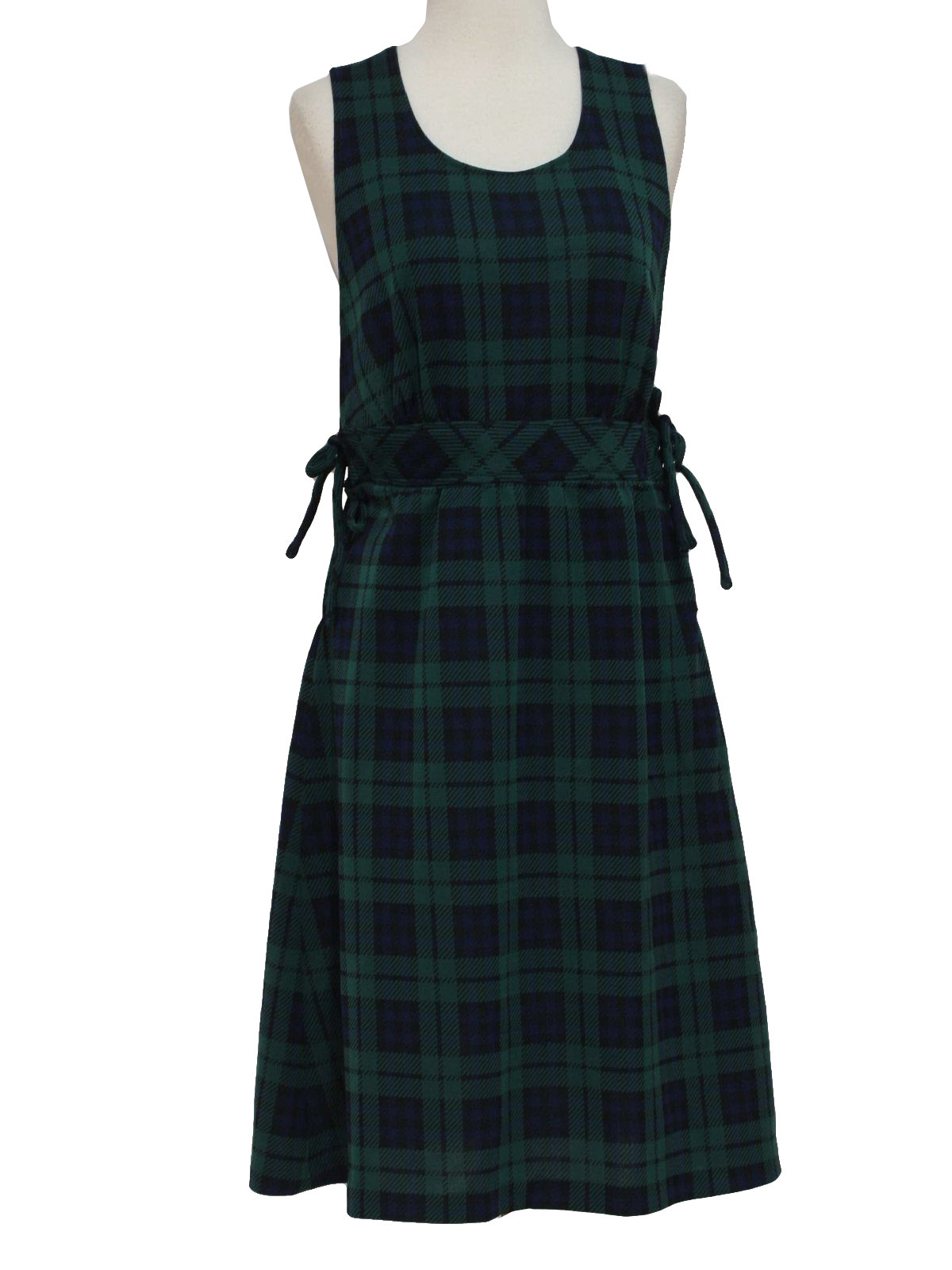 Seventies Vintage Dress 70s Care Label Only Womens navy blue green and black plaid lightweight polyester knit mid length sleeveless jumper dress with four side ties. A wholesome Catholic school girl...