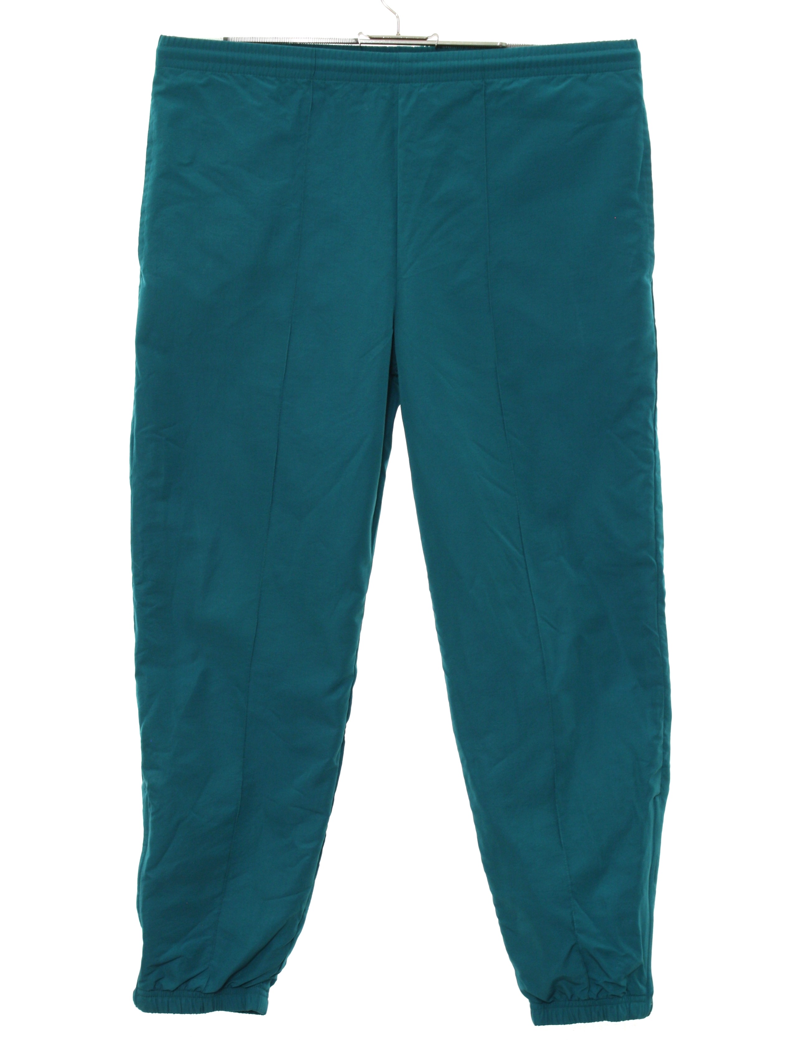 80's Head Pants: 80s -Head- Womens aqua green solid colored nylon shell ,  wide taper cut leg baggy totally 80s track pants with elastic cuff hem with  ankle zipper, vertical seam inset