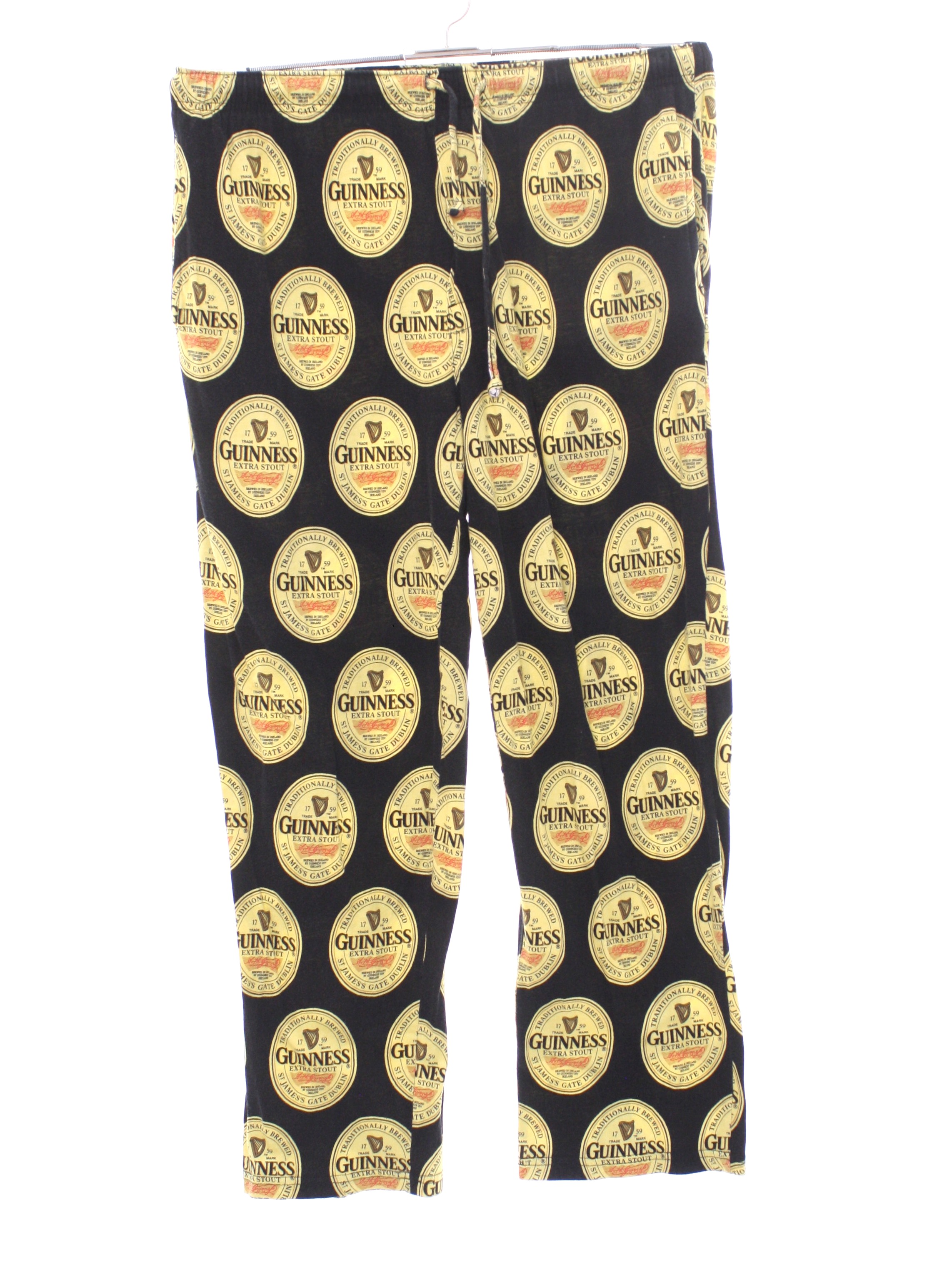 Nineties Guinness Official Merchandise Pants 90s Guinness Official Merchandise Mens black background with light gold golden tan and red Guinness beer label print cotton jersey knit baggy slightly ta...