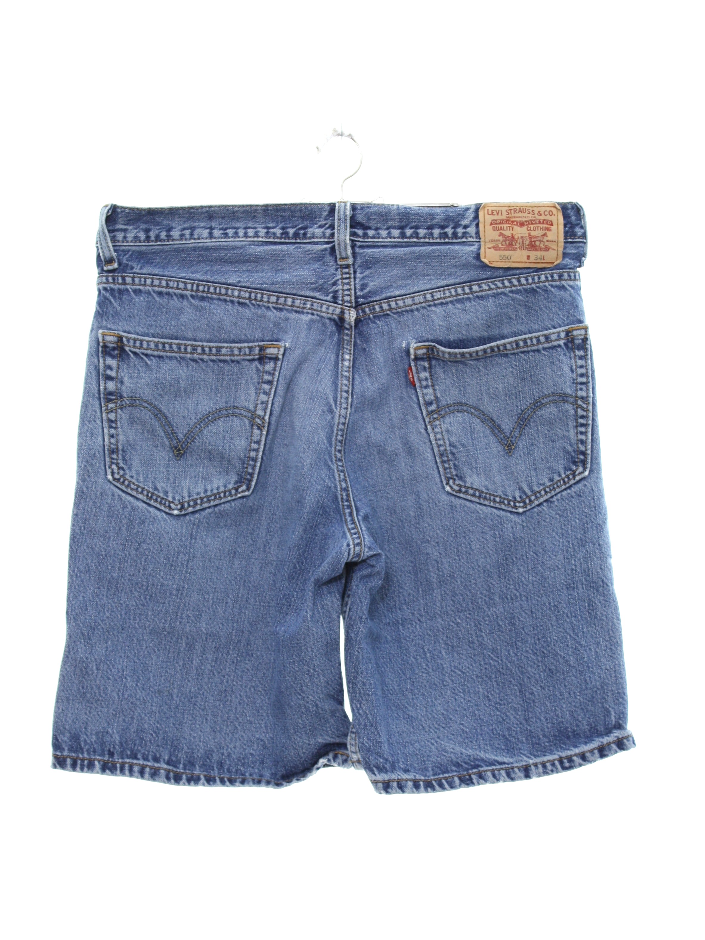 Levis 550 90's Vintage Shorts: Late 90s or Early 2000s -Levis 550- Mens  medium blue wash background cotton relaxed fit Levis 550 denim shorts.  Standard Levis style with small e red tab
