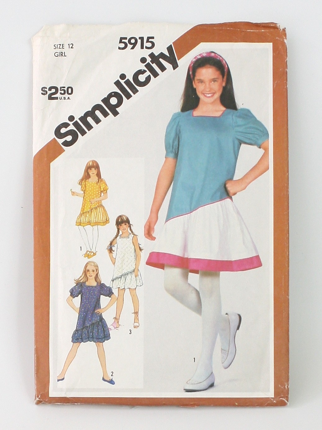 1980's Sewing Pattern: 80s -Simplicity Pattern No. 5915- Womens/Girls loose  fitting pullover dress having square neckline and asymmetrical lower  ruffle. Piping trimmed V 1 & 2 have skirt band set in sleeves