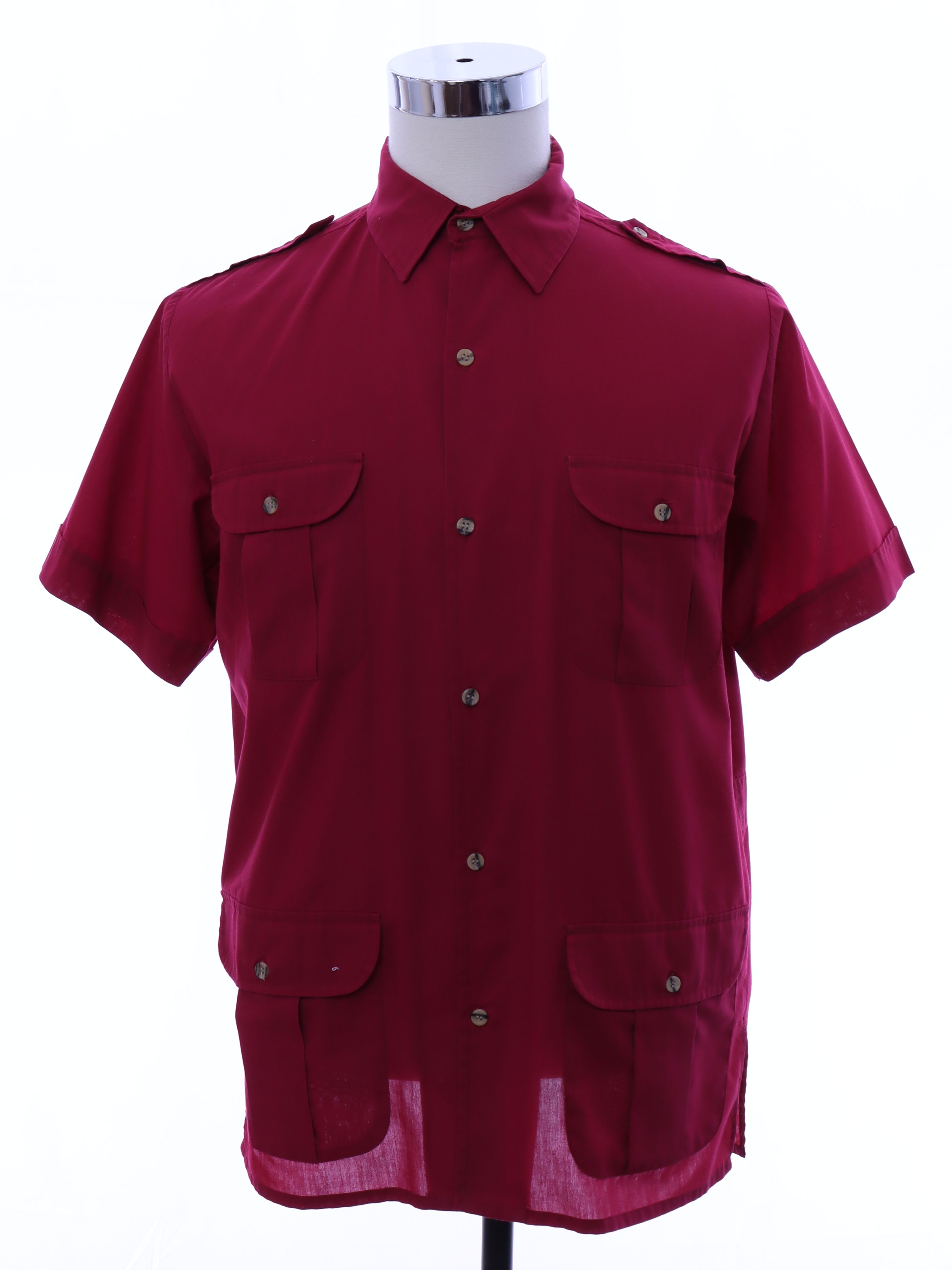 Shirt 90s Blair Mens cranberry red background polyester cotton blend short sleeve button up front safari sport shirt with shoulder epaulets. Fold over collar four flap pockets with button closure an...