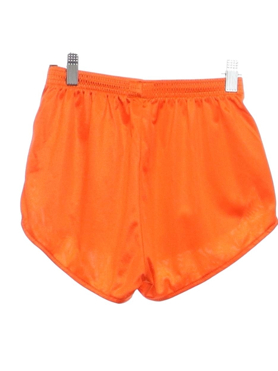 Retro 80s Shorts Dolfin International 80s Dolfin International Womens bright sheeny orange nylon running style shorts. Elastic pull on waistband notched legs with Dolfin logo on the left leg no pock...