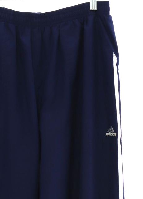 Pants: 90s -Adidas- Unisex midnight blue nylon shell track pants with  cuffless hem, front slant side entry pockets, one rear inset pocket with  velcro closure, elastic waistline, nylon mesh lining. Slightly tapered